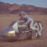 LA Priest riding a custom-built synth-bike through the Joshua Tree desert in the Into The Sky music video