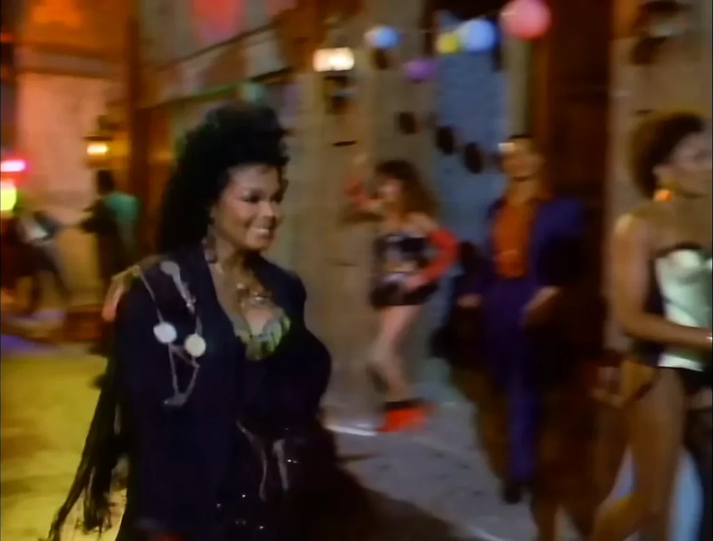 Janet Jackson walks through the colorful neighborhood in the When I Think of You music video