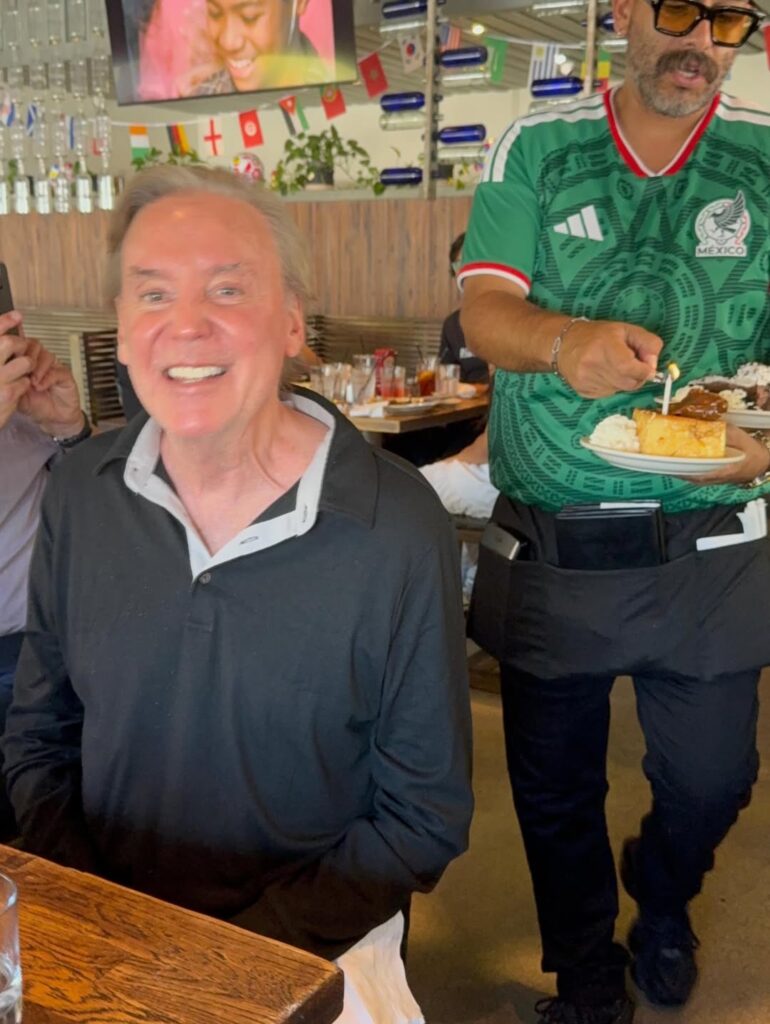 Mark Kriski smiling with birthday dessert at his KTLA lunch.