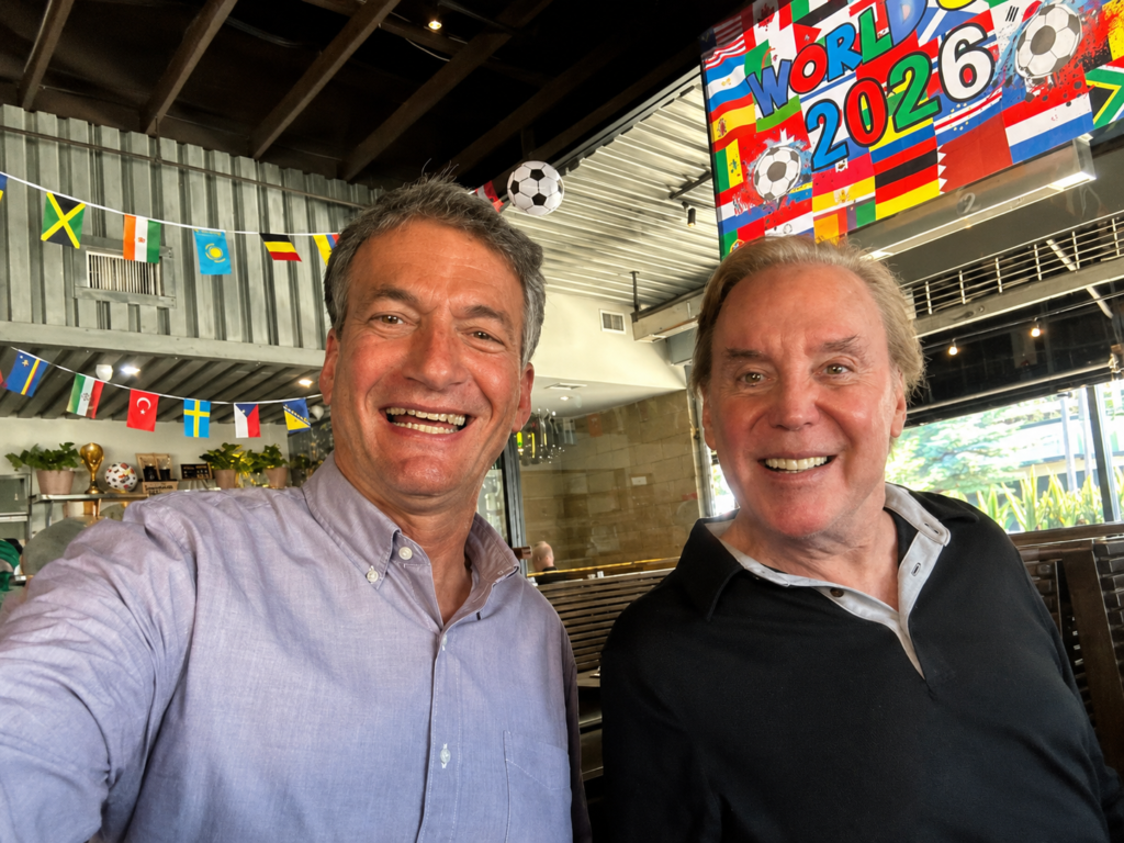Mark Kriski and Eric Spillman smiling together at a KTLA birthday lunch.