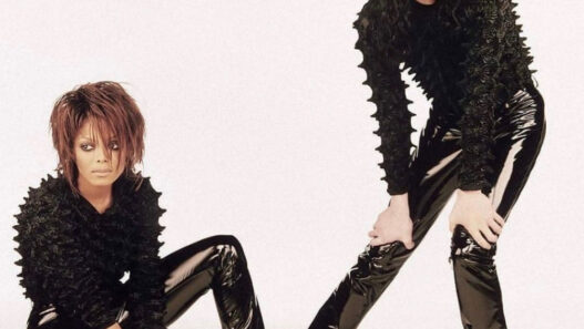 Janet Jackson leaning against Michael Jackson during the futuristic Scream music video era