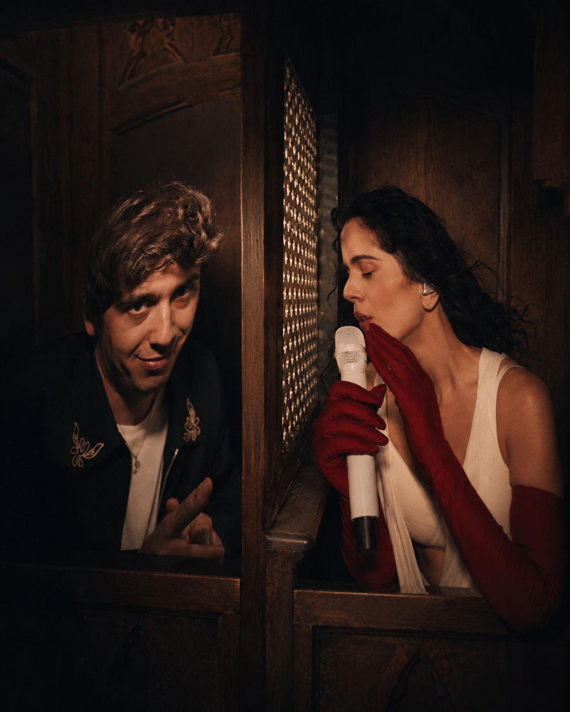 Marcello Hernández seated with Rosalía during her LUX Tour confessional segment in New York City