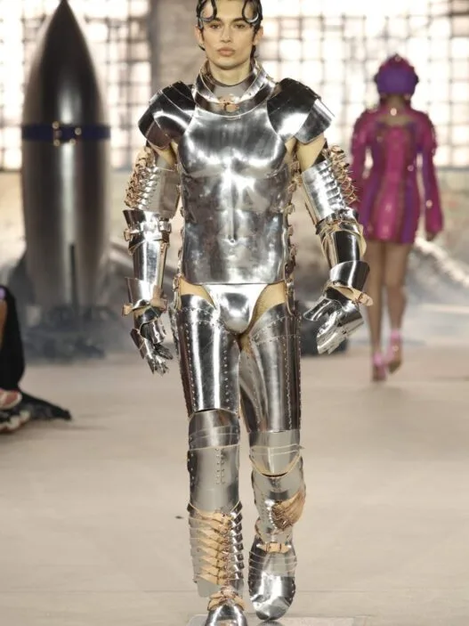 Model walks the Berlin Fashion Week runway in a bold Marina Hoermanseder SS27 Outer Space collection look.