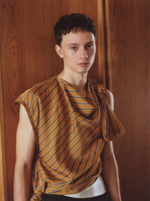 A model wearing Timothy Li’s Series 3 collection inside its intimate apartment setting