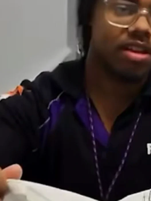 Titan the iguana leaping from a shipping box inside a Memphis FedEx store