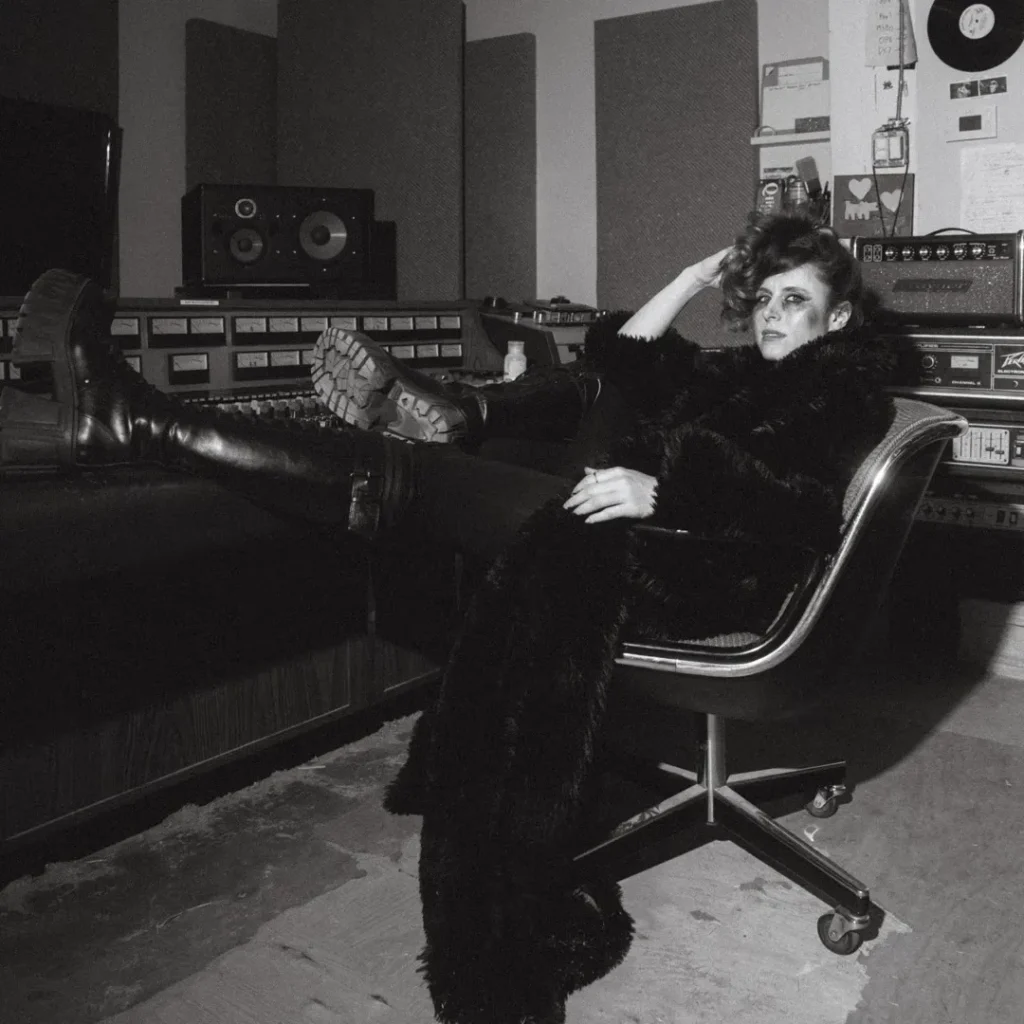 Kiesza reclining in a recording studio in the black-and-white artwork for All Star