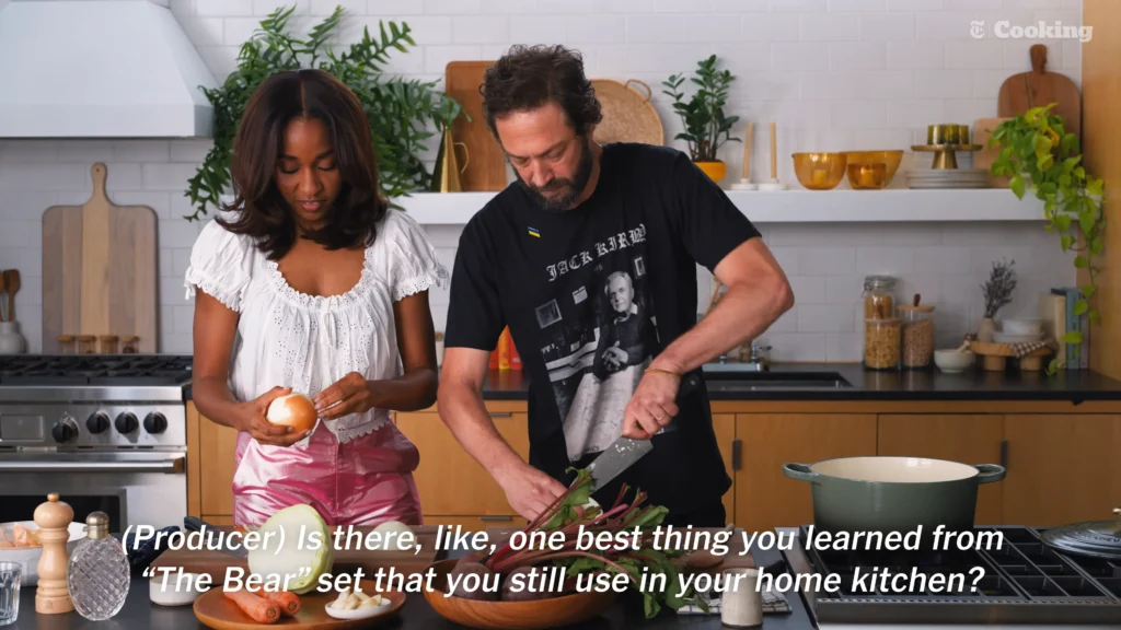 Ayo Edebiri chopping vegetables while Ebon Moss-Bachrach prepares borscht