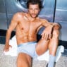 Sam Salter modeling CDLP Grey Melange Essentials inside a South London laundromat