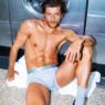 Sam Salter modeling CDLP Grey Melange Essentials inside a South London laundromat