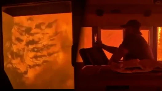 Bright orange wildfire flames surround a CN Rail train near Armstrong, Ontario