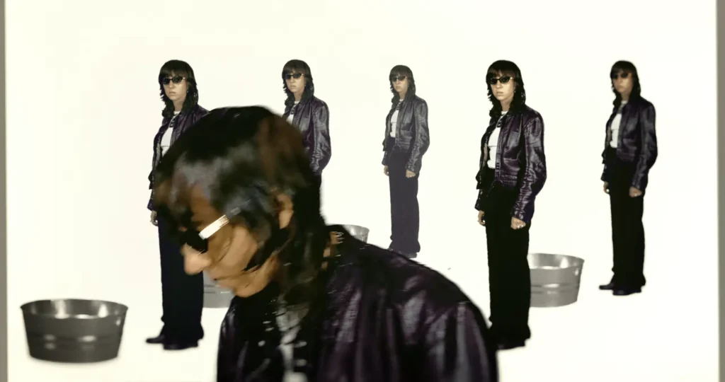 Repeated full-body images of Chloé Caillet in sunglasses and a leather jacket across a white background