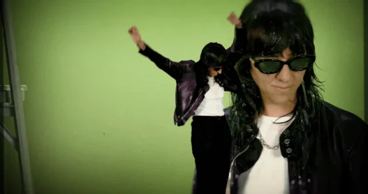 Chloé Caillet appearing in layered duplicate images against a green background in the Bad Bara music video