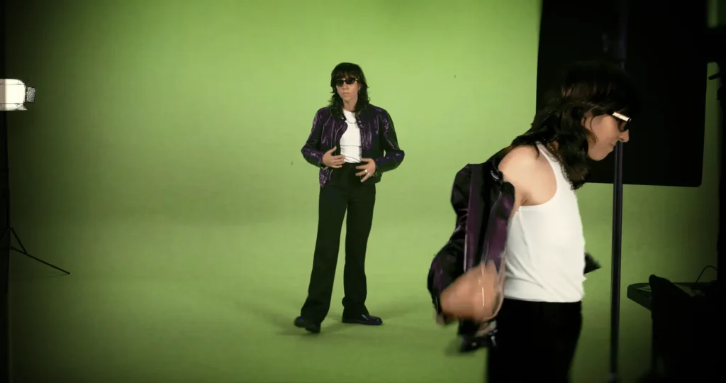 Two versions of Chloé Caillet dancing on a green-screen studio set in the Bad Bara video