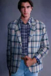 Model wears a layered look from ERL Spring/Summer 2027 by Eli Russell Linnetz.