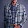 Model wears a layered look from ERL Spring/Summer 2027 by Eli Russell Linnetz.