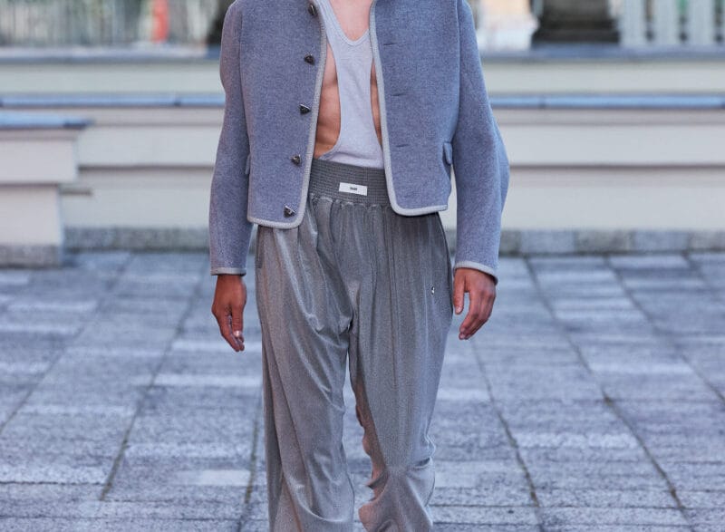 A model walks the GmbH Winter/Spring 2027 runway at Berlin Fashion Week in a structured dark look.