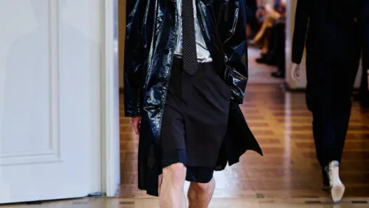 A model opens the John Lawrence Sullivan Spring/Summer 2027 runway at Berlin Fashion Week in a sharp black look.
