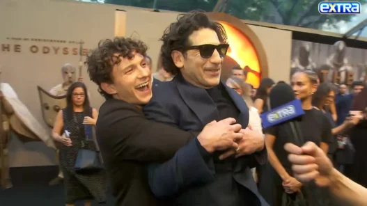 Tom Holland smiling as he crashes Jon Bernthal’s interview at The Odyssey New York premiere