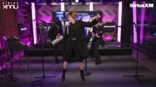 Katie Gavin singing as MUNA performs Wannabeher live at SiriusXM