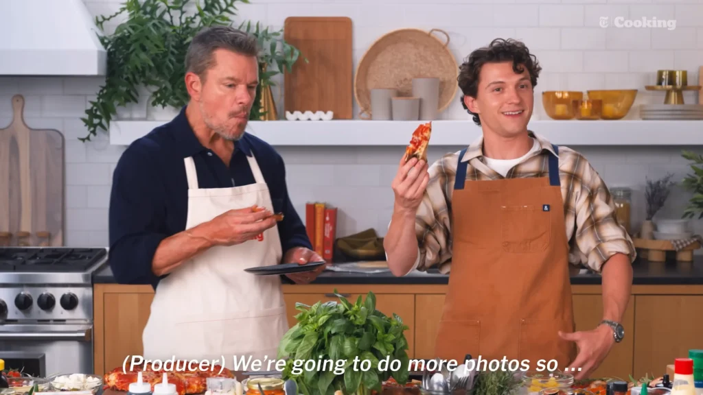 Matt Damon and Tom Holland beginning the pizza-making process in the NYT Cooking kitchen