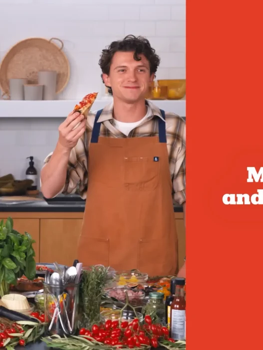 Matt Damon and Tom Holland presenting their finished pizzas during NYT Cooking’s Pizza Interview