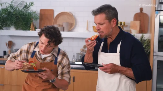 Matt Damon and Tom Holland presenting their finished pizzas during NYT Cooking’s Pizza Interview