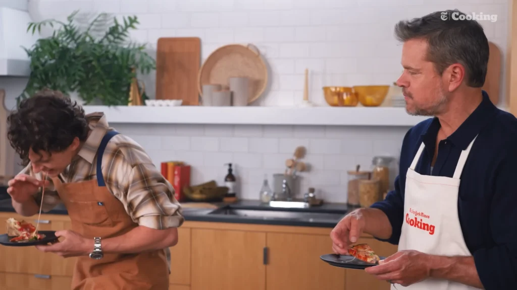 Matt Damon and Tom Holland examining their finished pizzas near the end of The Pizza Interview