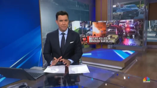 Tom Llamas reporting from the NBC Nightly News desk with images from the deadly Bangkok bar fire behind him
