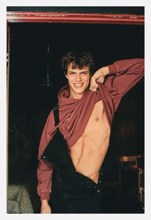 Model Nils Bremer poses shirtless in a sunlit portrait by Adam Washington for MMSCENE