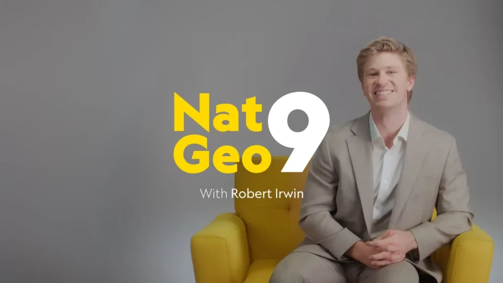 Robert Irwin smiling in National Geographic’s yellow chair during the Nat Geo 9 interview