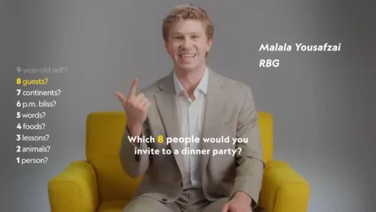 Robert Irwin smiling in National Geographic’s yellow chair during the Nat Geo 9 interview
