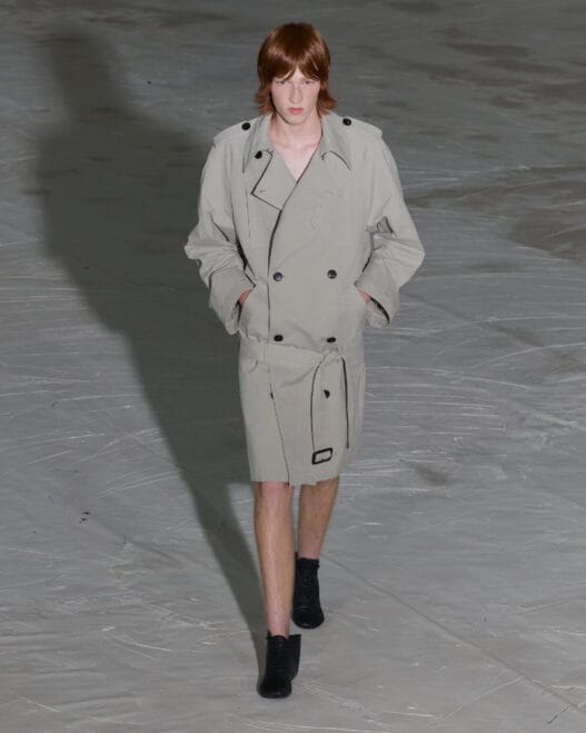 A model walks the SF1OG Spring/Summer 2027 runway at Berlin Fashion Week in a dark, ritual-inspired look.