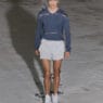 A model walks the SF1OG Spring/Summer 2027 runway at Berlin Fashion Week in a dark, ritual-inspired look.