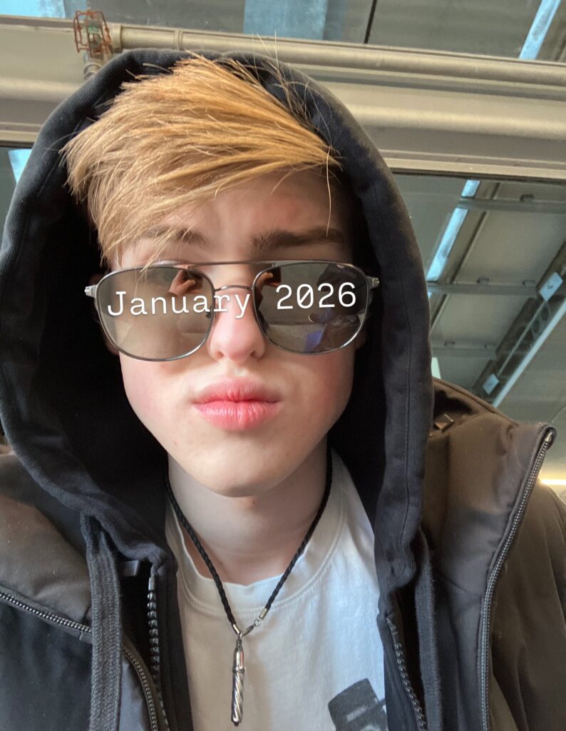 Iain Armitage wearing a hood and sunglasses in a January 2026 close-up selfie