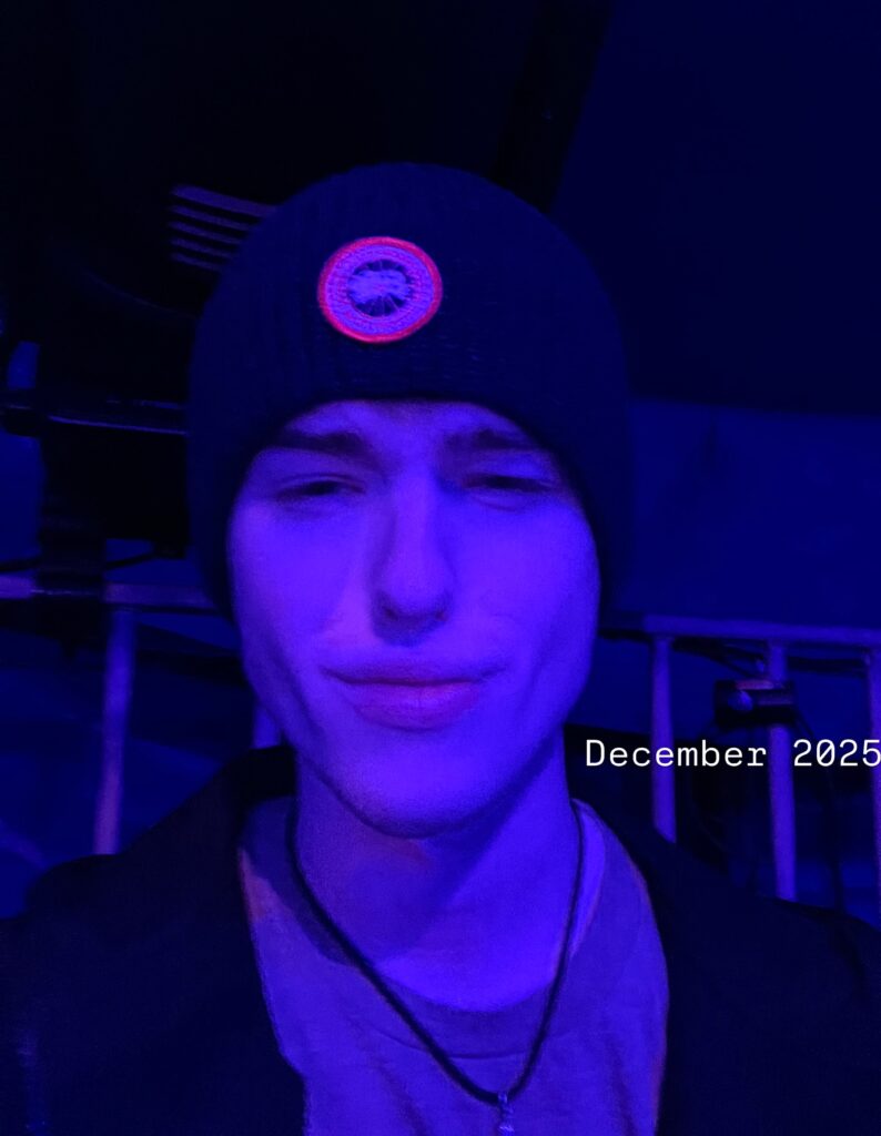 Iain Armitage in a knit cap under blue lighting in December 2025