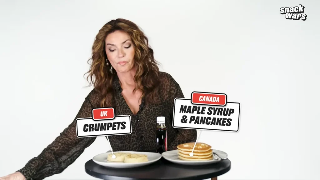 Shania Twain reacts while tasting food during the Canada versus UK edition of Snack Wars