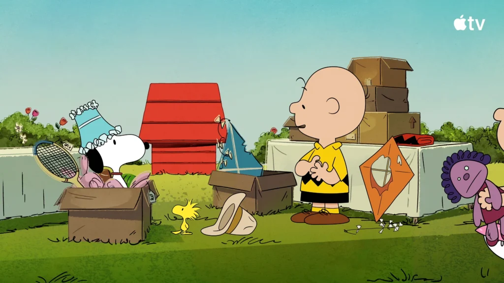 Charlie Brown and Snoopy standing among boxes and household items at a neighborhood yard sale