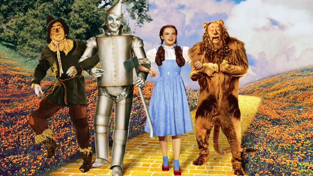 Judy Garland as Dorothy stands with the Scarecrow, Tin Man and Cowardly Lion in The Wizard of Oz