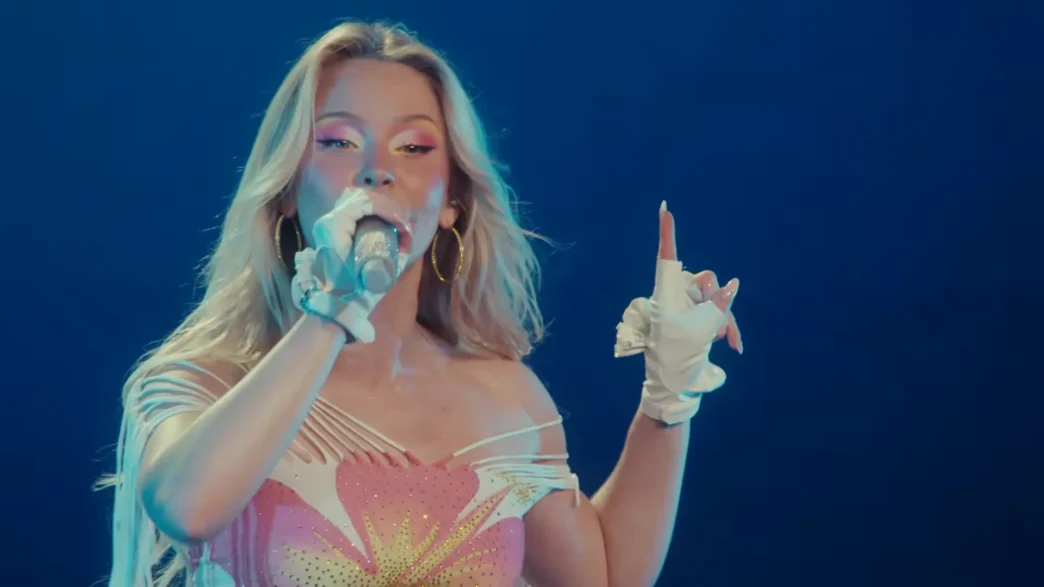 Zara Larsson performing beneath blue stage lights during her Montreux Jazz Festival 2026 set