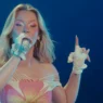 Zara Larsson performing beneath blue stage lights during her Montreux Jazz Festival 2026 set
