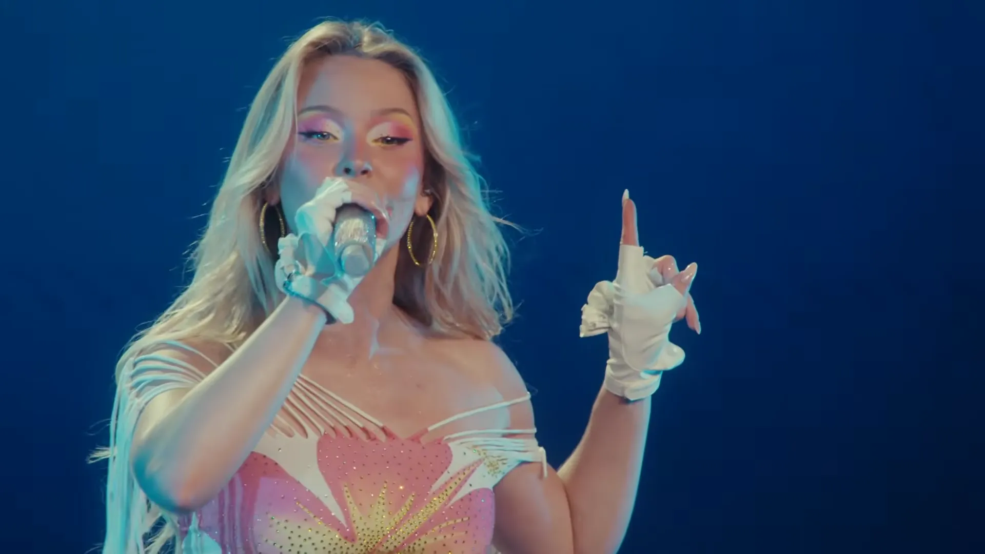 Zara Larsson performing beneath blue stage lights during her Montreux Jazz Festival 2026 set