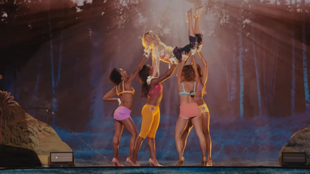 Zara Larsson performing with dancers under colorful lights at Montreux