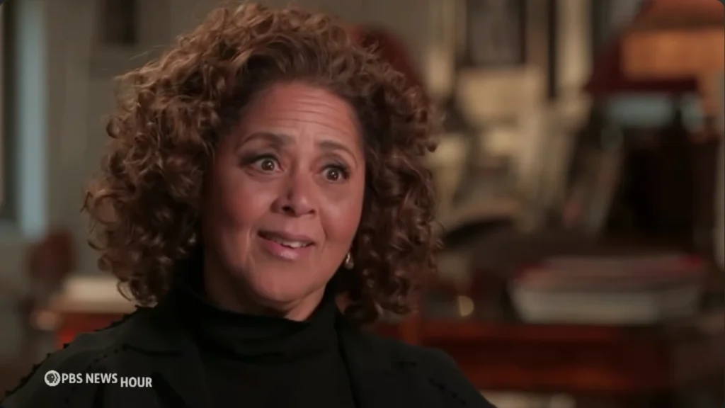 Anna Deavere Smith examining photographs and records connected to Basil Biggs