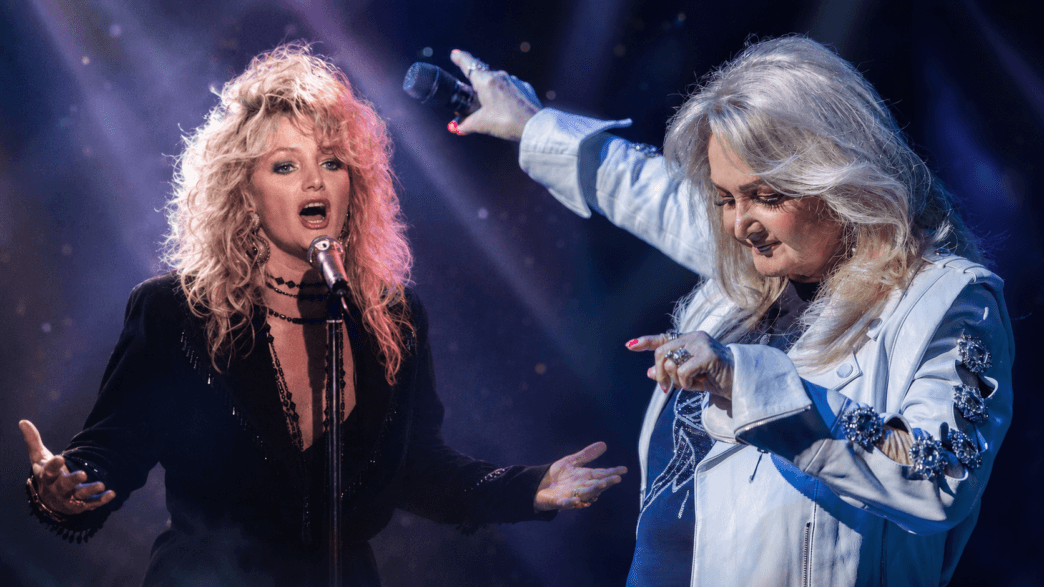 Bonnie Tyler performing on stage in a tribute-style header image that pairs a classic 1980s performance photo with a more recent concert image.