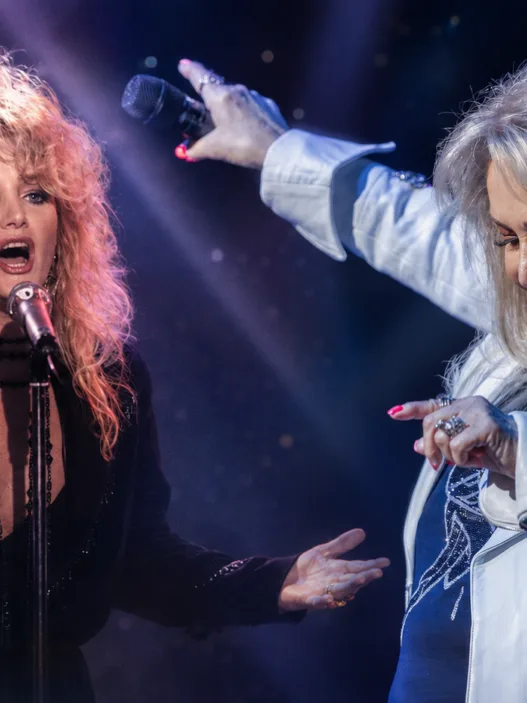 Bonnie Tyler performing on stage in a tribute-style header image that pairs a classic 1980s performance photo with a more recent concert image.