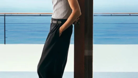 Pierrick Grégoire wearing a ribbed gray tank, wide-leg trousers and leather sandals for COS Summer 2026