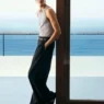 Pierrick Grégoire wearing a ribbed gray tank, wide-leg trousers and leather sandals for COS Summer 2026
