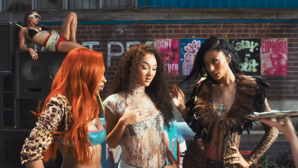 FLO appear together in a colorful still from the Remedied music video