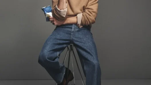 Thatcher Thornton modeling a camel crew neck and denim from FRAME’s Fall 2026 collection