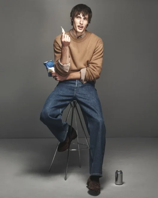 Thatcher Thornton modeling a camel crew neck and denim from FRAME’s Fall 2026 collection